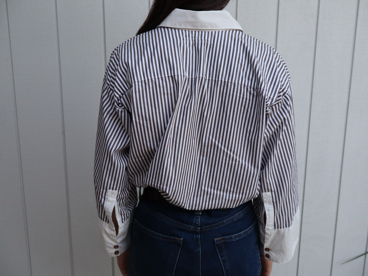 Back of the Ruth shirt. An oversized brown and white stripe shirt with white organic cotton cuffs and collar with brown natural corozo nut buttons. 
